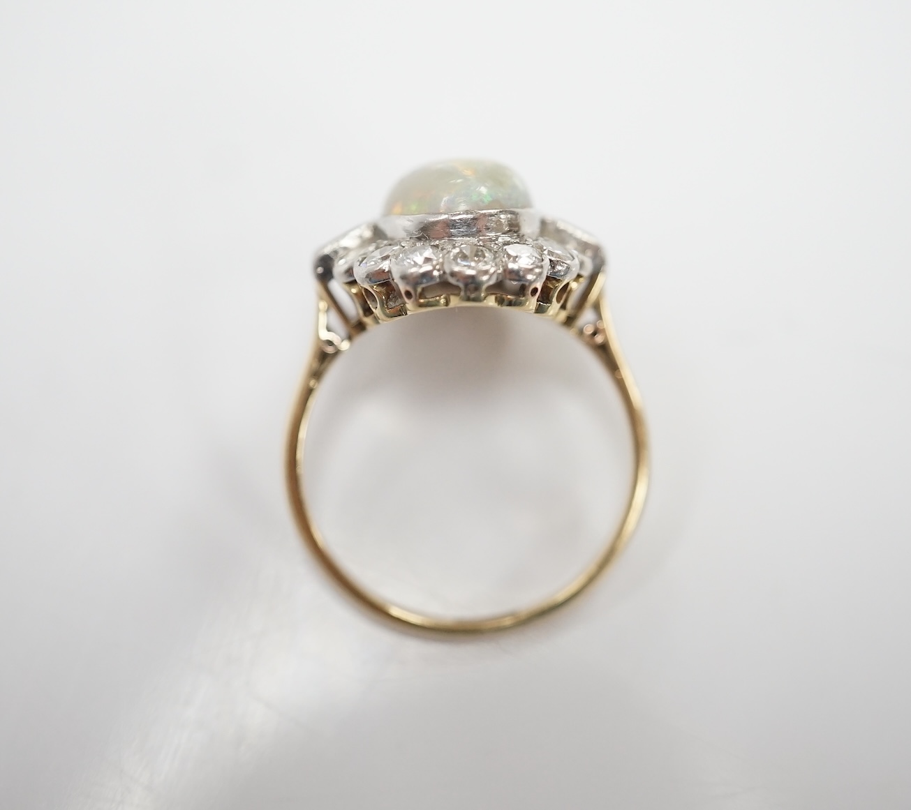 A mid 20th century 18ct, white opal, square and round cut diamond set oval cluster ring, size O, gross weight 3.3 grams. Condition - fair